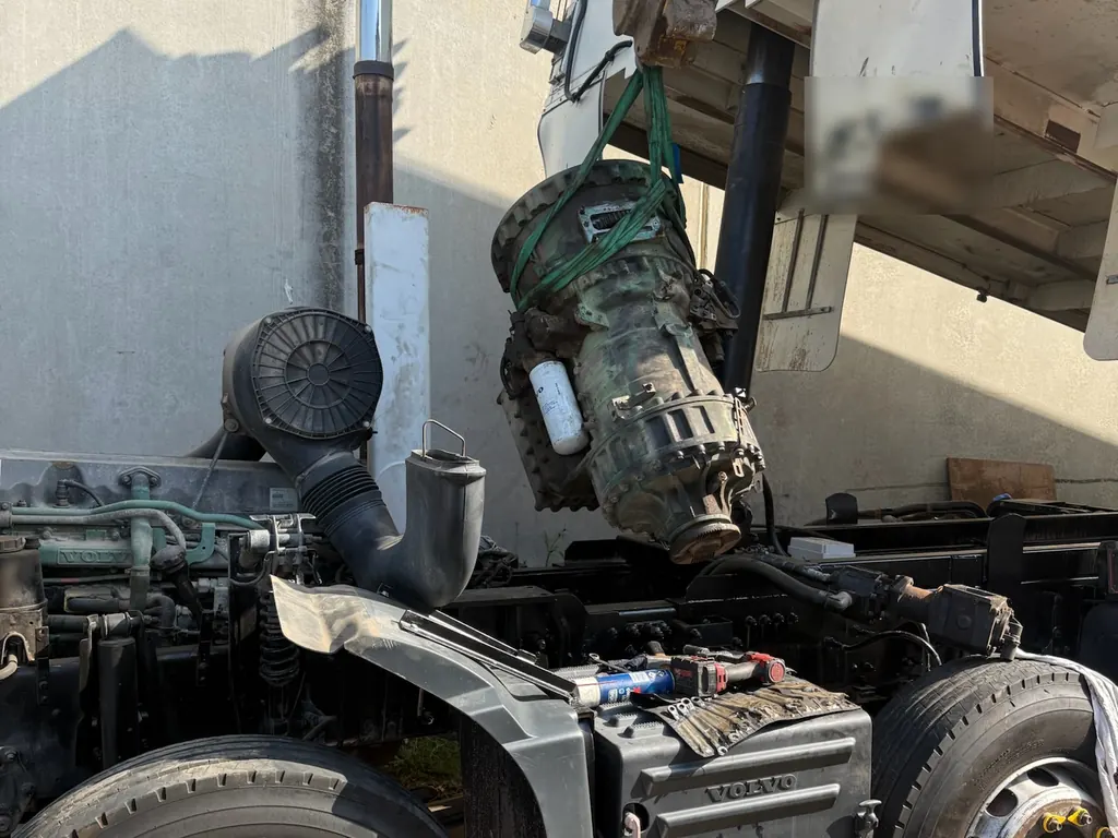 Gearbox being lifted out of a Volvo truck during an on-site job